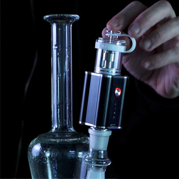 Linx Apollo: small Dab Rig and E Nail in Desktop mode with E Nail on glass Dab Rig on black background. 