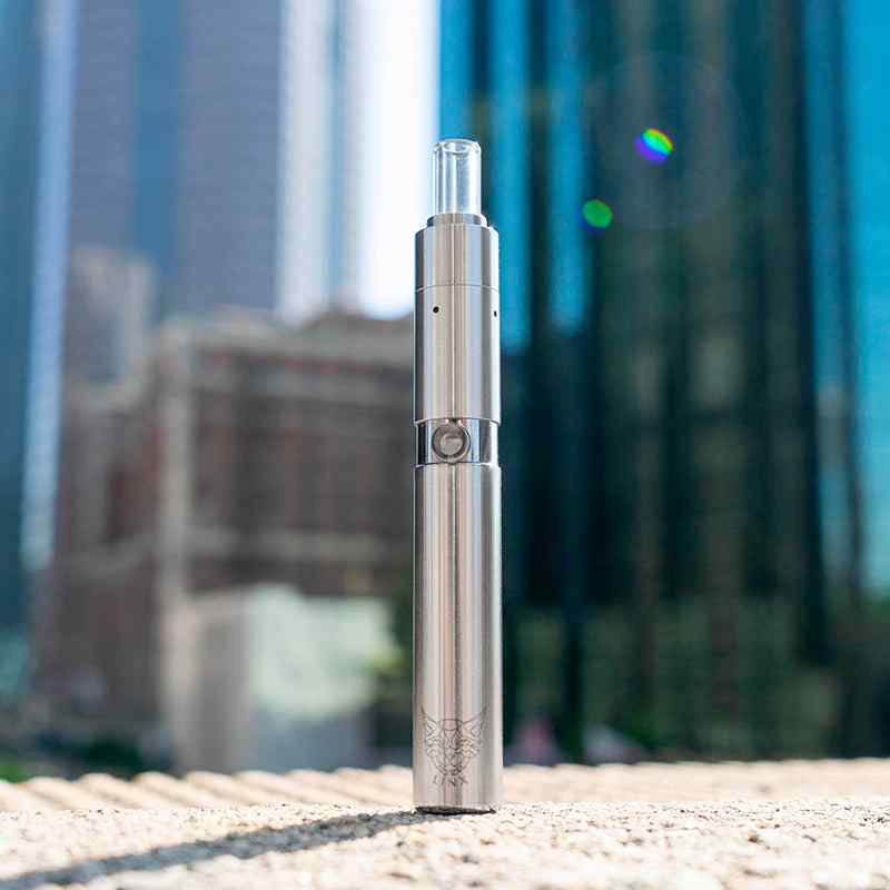 Linx-Hypnos Zero Concentrate Vaporizer Steel Outdoors on concrete ledge in front of buildings